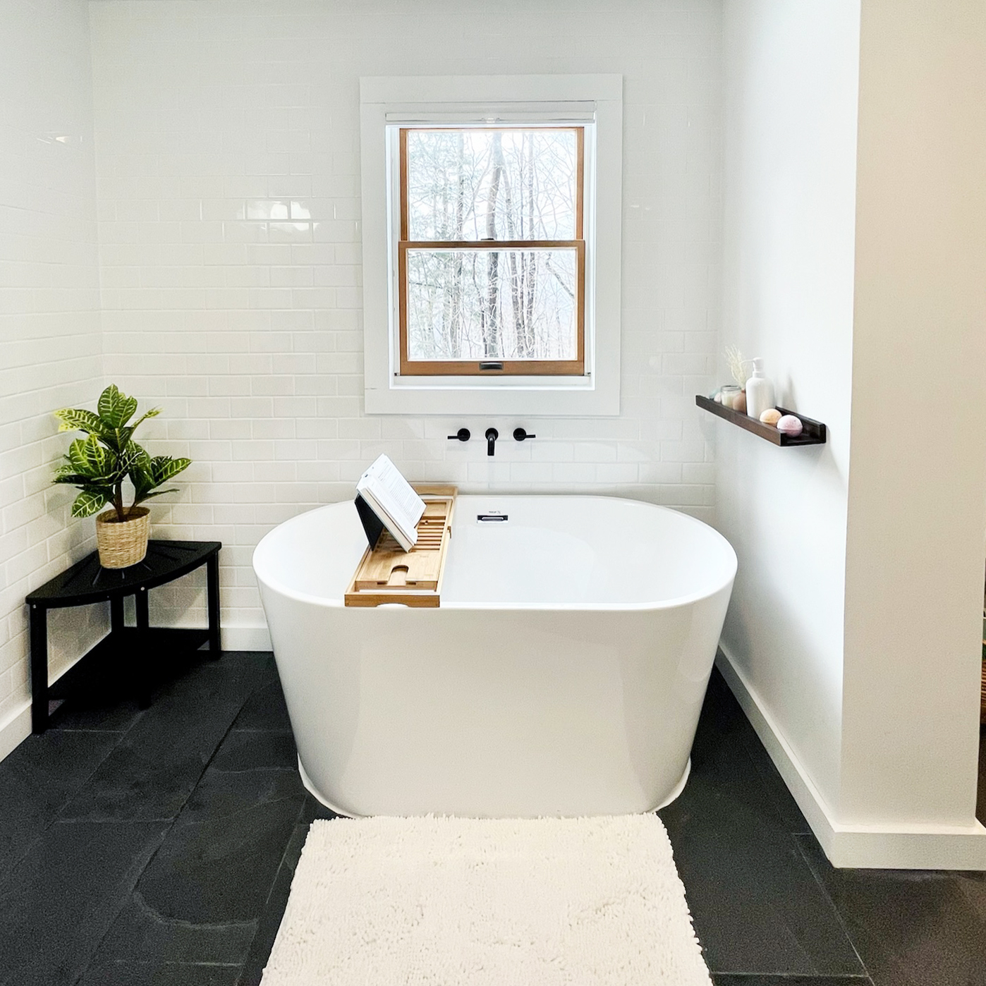 modern bathroom with soaking tub and slate floor